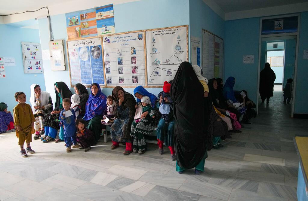 Pregnant and lactating women wait in line at a health clinic in central Afghanistan to receive medical and psychosocial support.